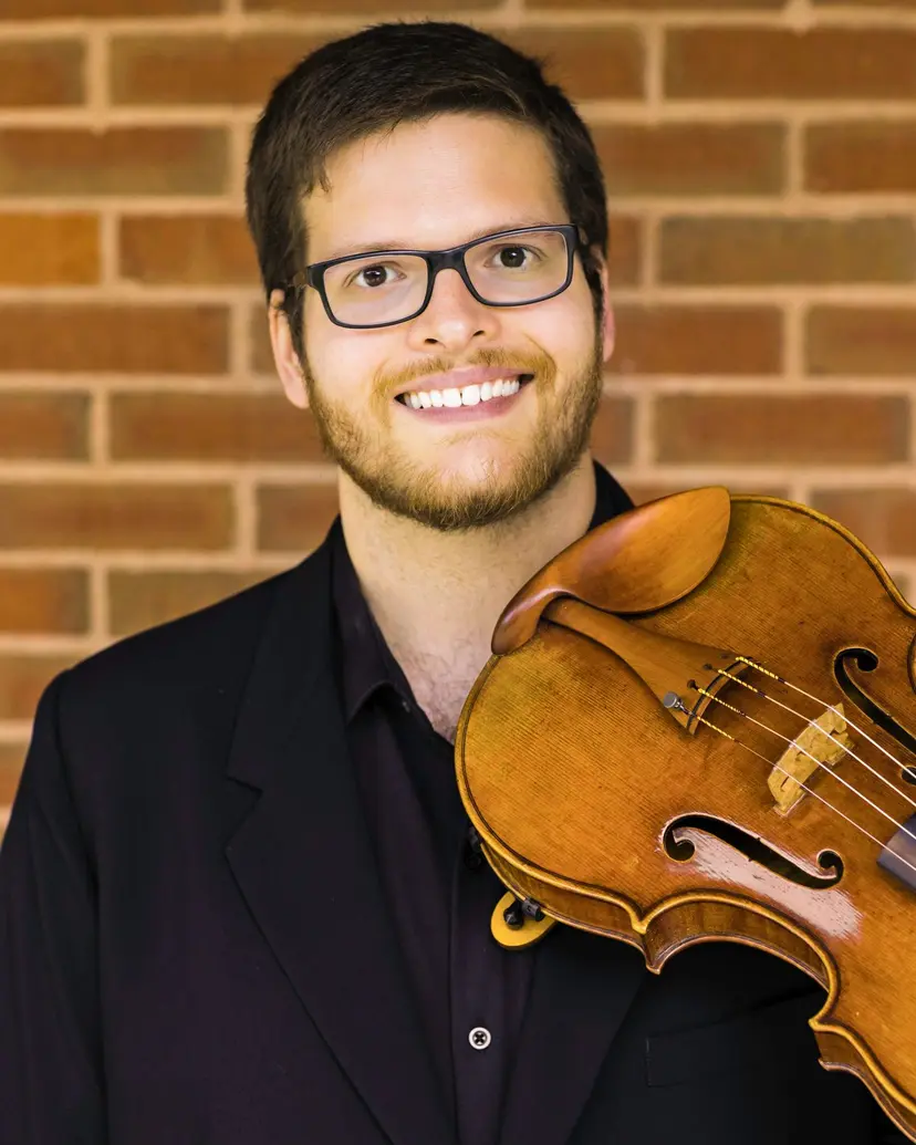 Eric Eakes, violin and viola teacher at Triad Suzuki Academy, holding his viola