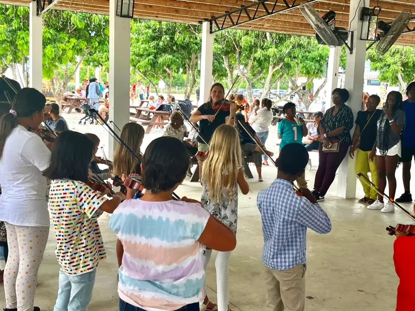 Young violin students playing together in a Triad Suzuki Academy group class
